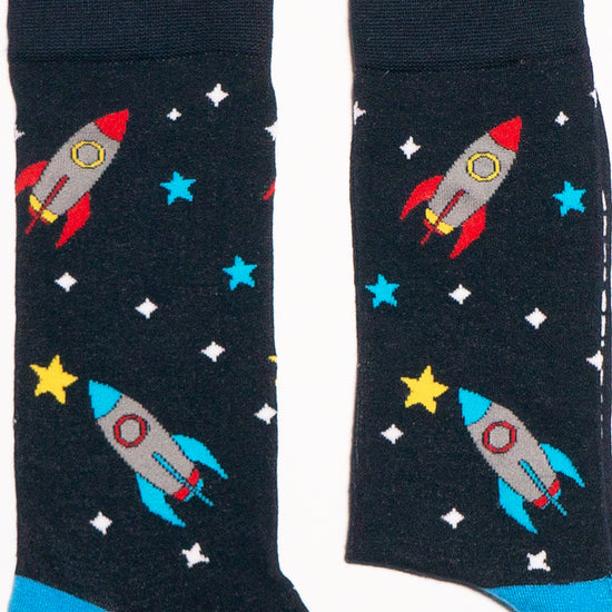 Socks that inspire us to remember those space exploration posters on our bedroom walls and and the days spent dreaming of blasting off to meet aliens from far off planets. Rocket-ships, stars, and, planets. Treat your feet to an out of this world experience.  Soft. Strong. Comfortable. Sustainable. Available in US Men’s 4-8 and 8-12