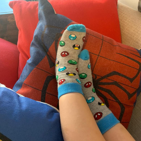 Kids socks with colorful superheroes on child's feet. Spider Man, Captain America, Iron Man, The Hulk. Made from sustainable bamboo.