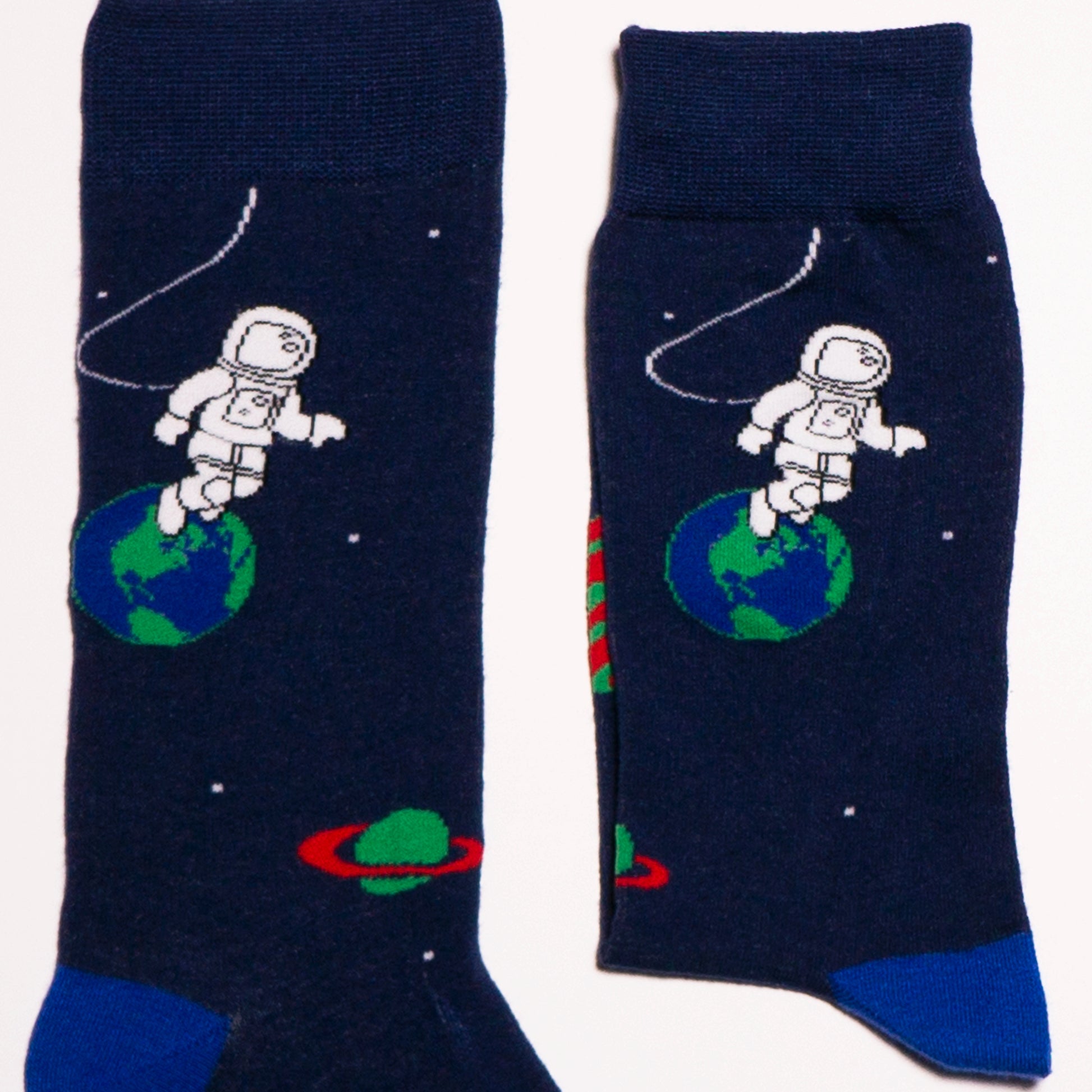 Socks that inspire us to remember those space exploration posters on our bed room walls and days spent dreaming of blasting off to meet aliens from far off planets. Space explorers, planets and tons of adventure awaits.  Soft. Strong. Comfortable. Sustainable. Available in US Men’s 4-8 and 8-12