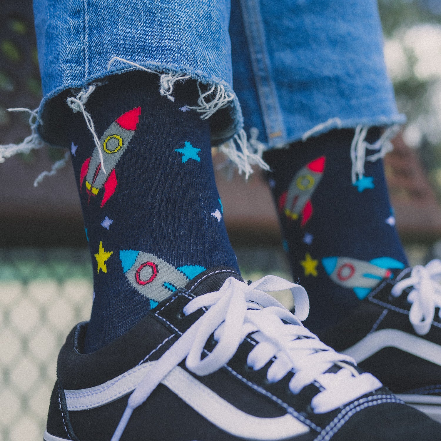 Socks that inspire us to remember those space exploration posters on our bedroom walls and and the days spent dreaming of blasting off to meet aliens from far off planets. Rocket-ships, stars, and, planets. Treat your feet to an out of this world experience.  Soft. Strong. Comfortable. Sustainable. Shown here on a pair of feet with sports style shoes and blue jeans. Available in US Men’s 4-8 and 8-12.  Incredible Socks