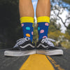 Who doesn't love the nostalgia of the 1980s retro, arcade games. What was your PacMan high score? Fun, comfortable socks that are a bold reminder of our misspent youth. An Incredible Socks collaboration with Andy Awesome, a Munich based 90's child who makes art out of the heroes of his childhood (and ours!).  Soft. Strong. Comfortable. Sustainable. Shown here in the middle of a quiet street on a pair of feet.  Available in US Men’s 4-8 and 8-12. Incredible Socks. Pac Man