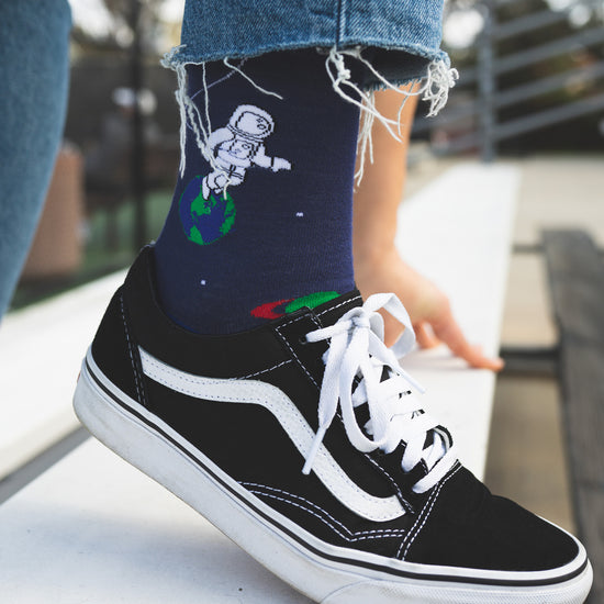 Socks that inspire us to remember those space exploration posters on our bed room walls and days spent dreaming of blasting off to meet aliens from far off planets. Space explorers, planets and tons of adventure awaits.  Soft. Strong. Comfortable. Sustainable. Available in US Men’s 4-8 and 8-12