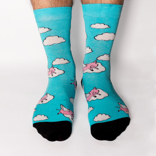 One of our most popular designs. The perfect shade of blue meets our lovable pink pigs - who said these guys could not fly! Soft. Strong. Sustainable. Comfortable.  Pigs! On Socks. We know! Madness.  Available in US Men’s 4-8 and 8-12