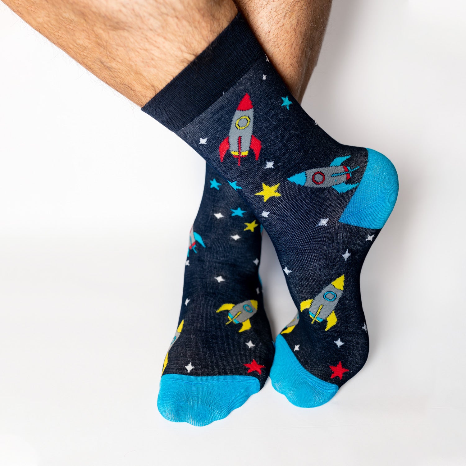 Socks that inspire us to remember those space exploration posters on our bedroom walls and and the days spent dreaming of blasting off to meet aliens from far off planets. Rocket-ships, stars, and, planets. Treat your feet to an out of this world experience.  Soft. Strong. Comfortable. Sustainable. Available in US Men’s 4-8 and 8-12